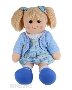 Mia is an cute doll with a soft cloth body and blonde hair tied in pigtails with bows and wears a pastel blue whimsical printed dress and cardigan.