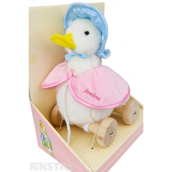 A gorgeous Jemima Puddle-Duck plush soft toy wears her signature blue poke bonnet and a pink shawl with 'Jemima' embroidered on it.