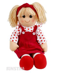 Audrey is cheerful doll with a soft cloth body and blonde hair in pigtails with a red headband and wears a red pinafore dress and white blouse patterned with little red hearts.