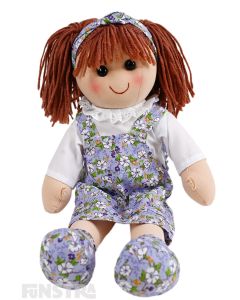 Emily is a sweet doll with a soft cloth body 
 with auburn hair tied in pigtails, wearing a headband and a lavender floral springtime print pinafore dress.