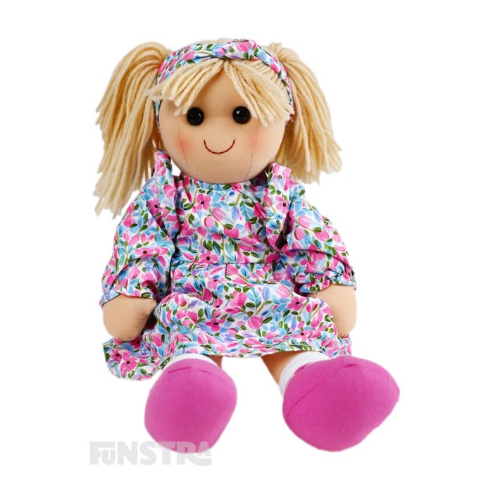 Holly is a fun darling doll with a soft cloth body with blonde hair tied in pigtails secured with a headband and wears a dress featuring a vibrant floral pattern. Holly is a fun darling doll with a soft cloth body with blonde hair tied in pigtails secured with a headband and wears a dress featuring a vibrant floral pattern.